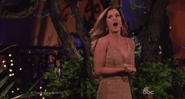 A Bachelorette contestant turning and looking surprised