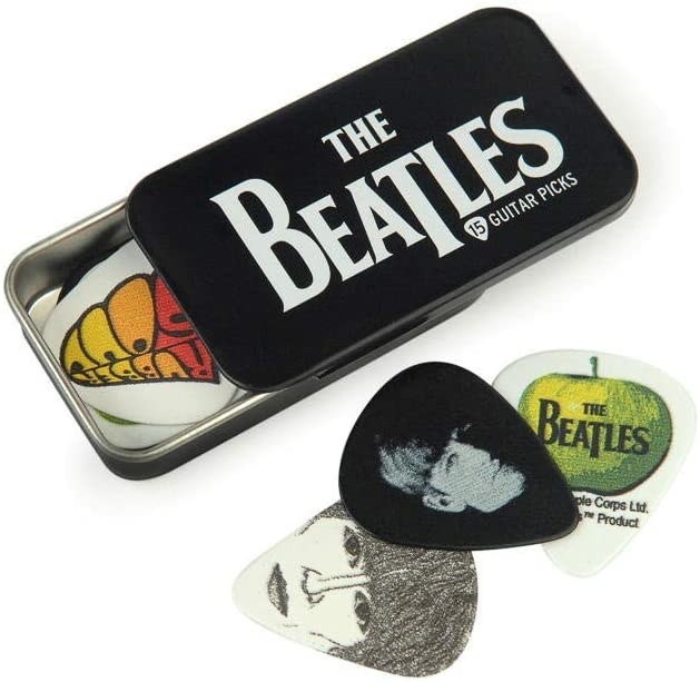 A tin pick holder with The Beatles&#x27; logo on it partially open and a variety of Beatles picks