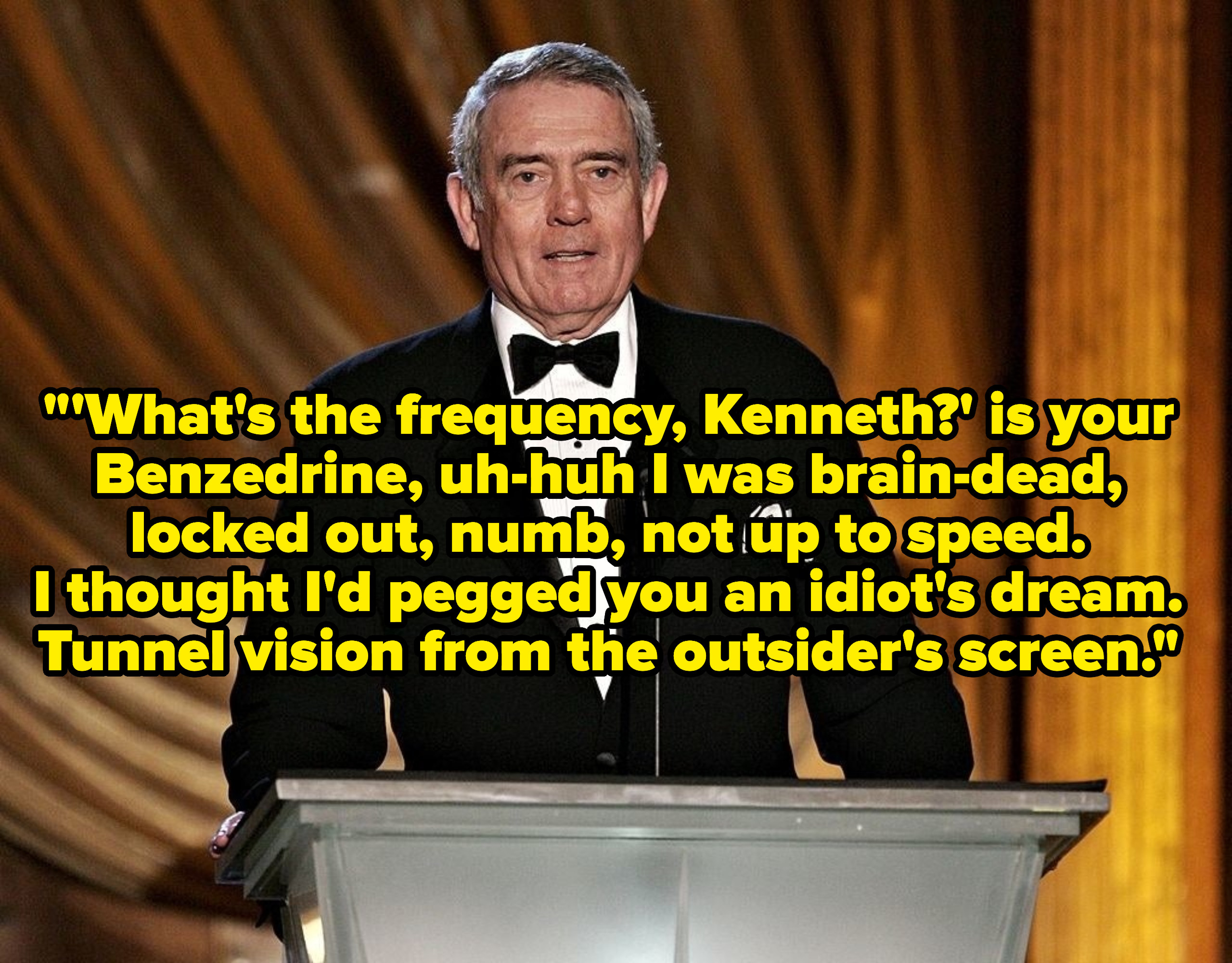 Dan Rather speaking at a podium, captioned with the lyrics to the song.