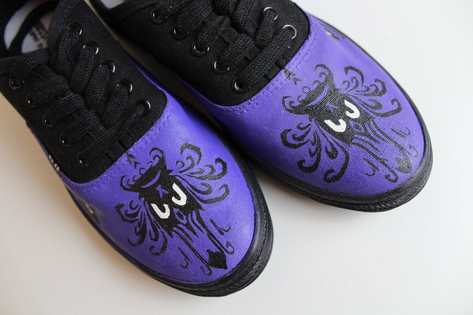 sneakers with the pattern of the Haunted Mansion wallpaper painted on them