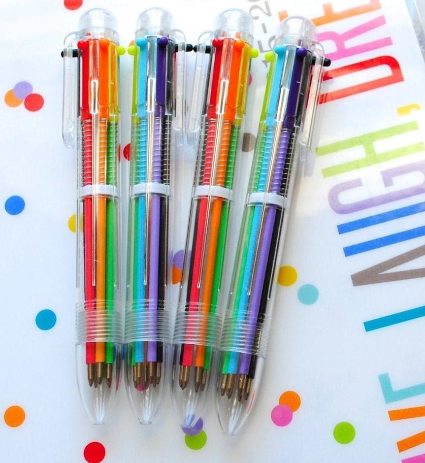 Four multi-colored pens in clear plastic 