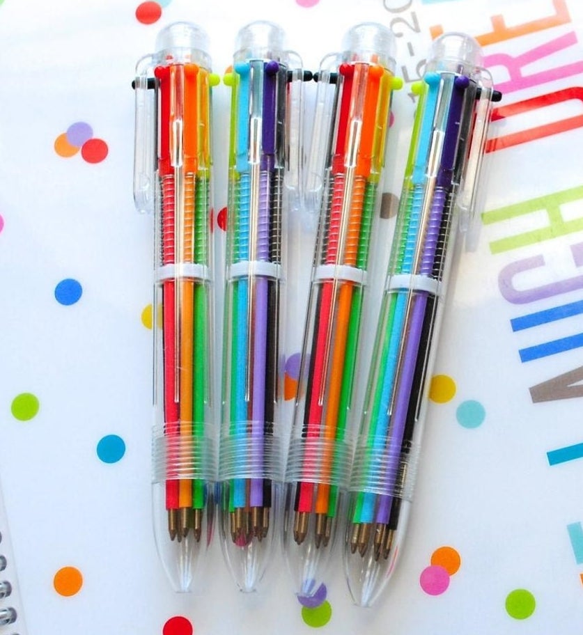 Four multi-colored pens in clear plastic