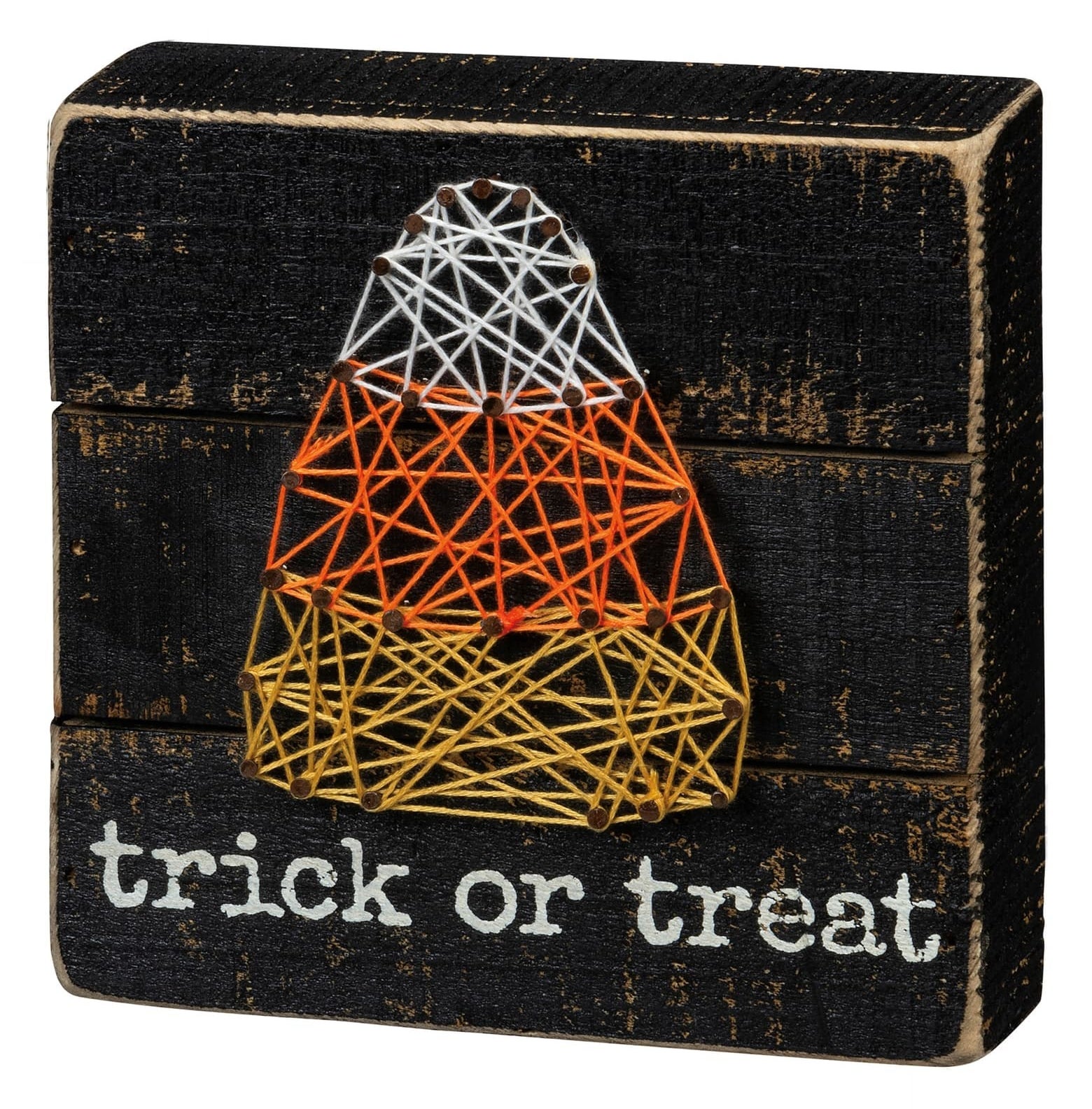 The black box sign says trick or treat in white letters and features a candy corn string art design 