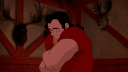 Gaston opening his shirt to reveal a hairy chest
