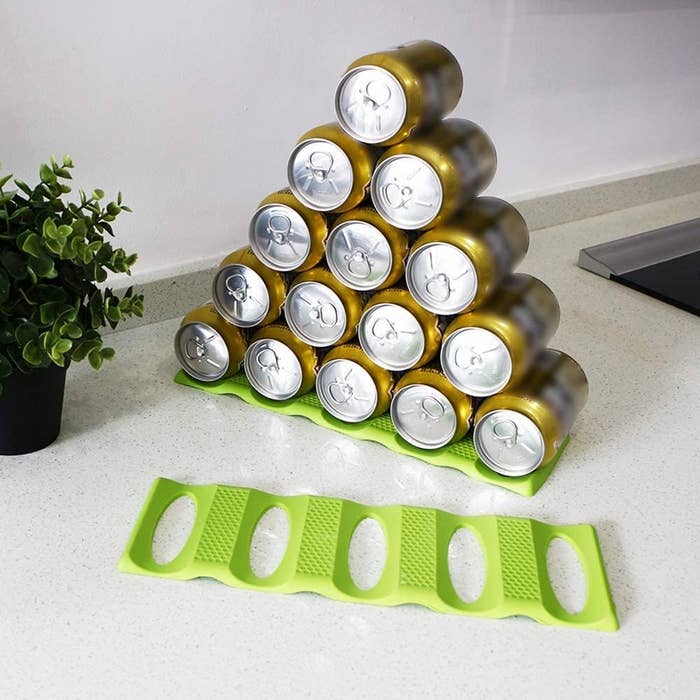 Fifteen cans stacked in a pyramid on the stacking mat