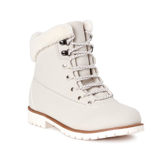 Cream colored boot with white laces and fur trim