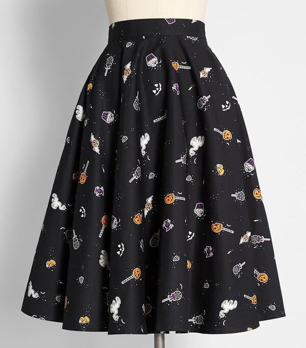 The black mini skirt on a mannequin with a print of various Halloween treats like cake pops and cupcakes