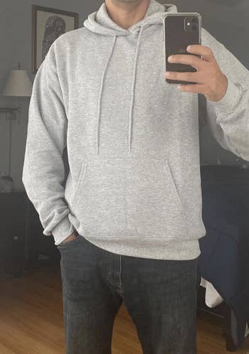 Reviewer in a gray hoodie with a front pocket and drawstrings at the collar 