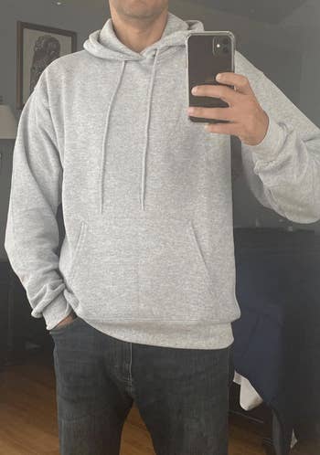 Reviewer in a gray hoodie with a front pocket and drawstrings at the collar 