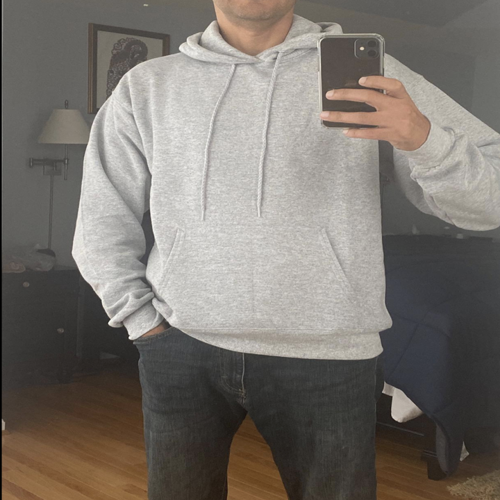 Reviewer in a gray hoodie with a front pocket and drawstrings at the collar 