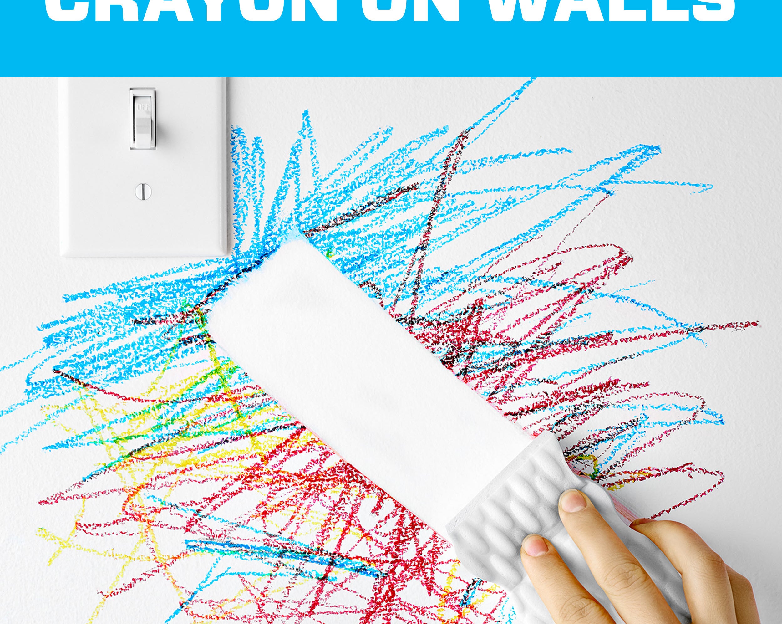 person using mr. clean magic eraser to remove crayon marks from a wall