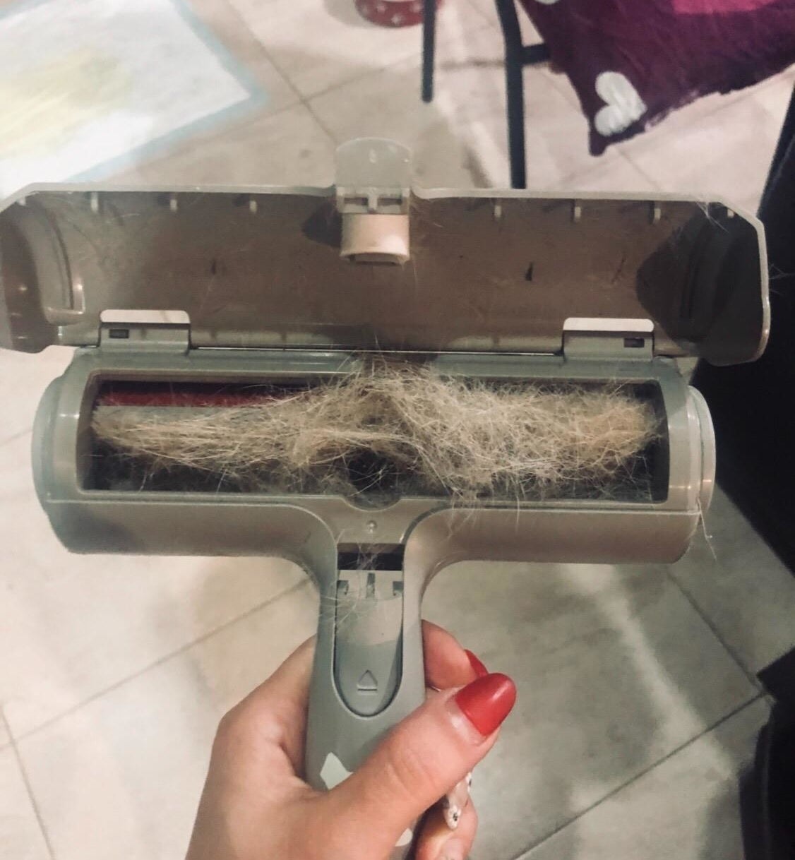 reviewer showing all of the pet hair in their roller 