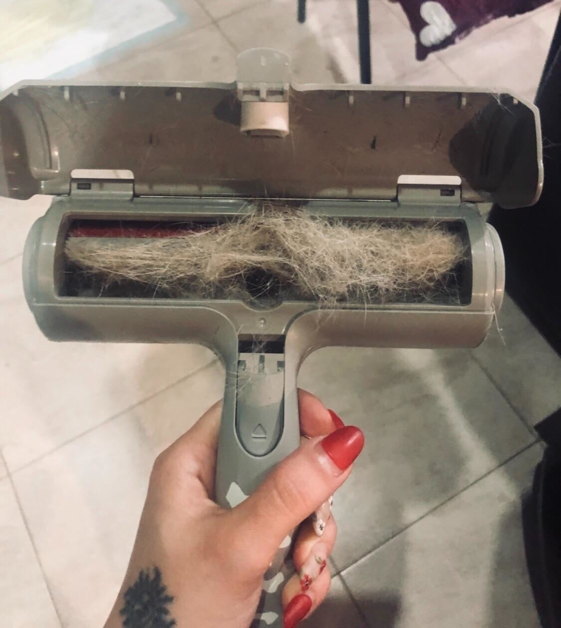 A person holding the pet hair roller