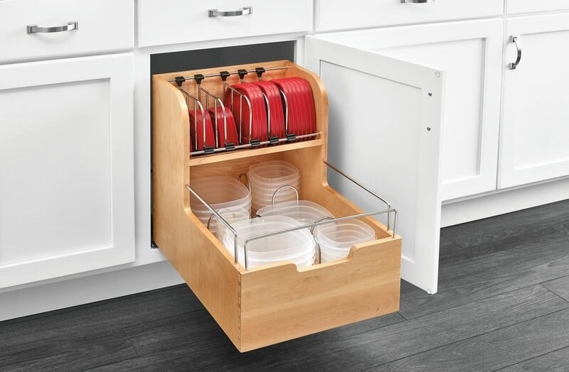 a two-tiered wooden pantry storage insert pulled out of a cabinet
