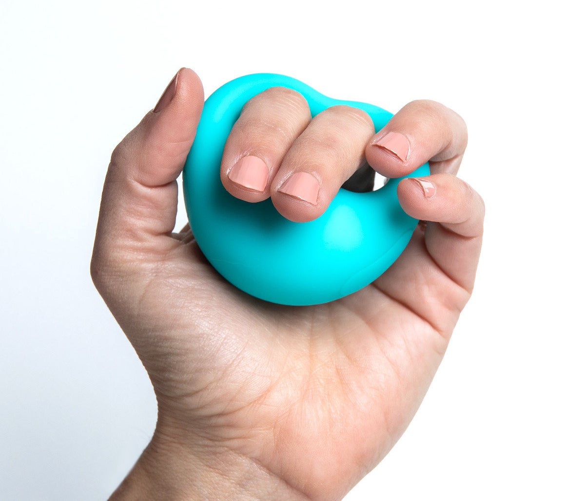 A hand holding the blue silicone toy, with the index and middle fingers inserted into the ergonomic grip