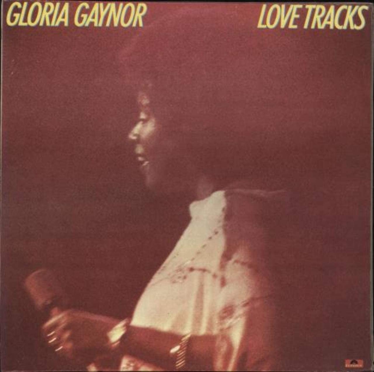 album cover of Love Tracks with Gloria Gaynor facing the side as she holds a mic