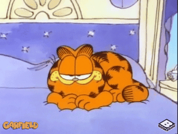 Animated cat Garfield snuggles into bed for a nap