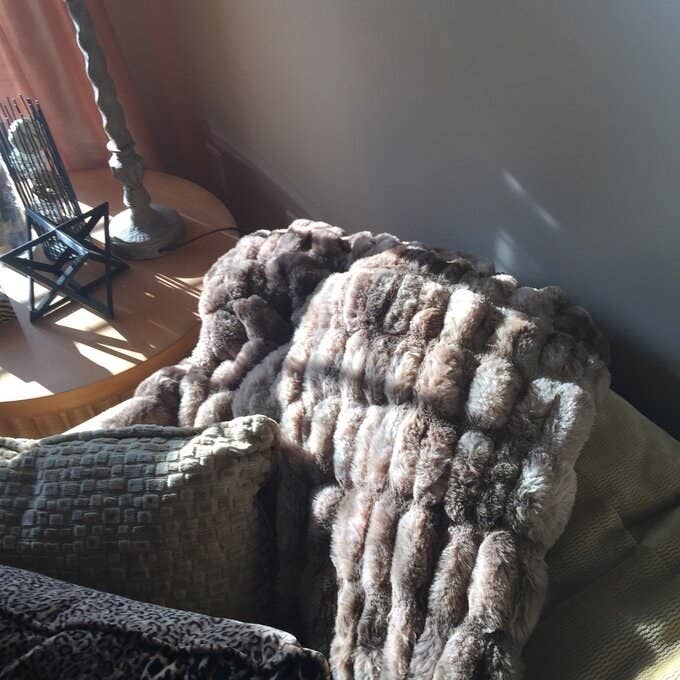 Reviewer&#x27;s picture of the extra plush blanket in grey