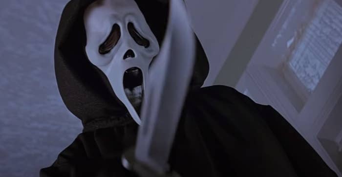 Scream mask man holding a knife