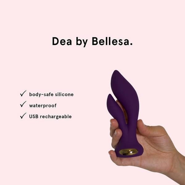 A hand holding the purple toy, made of body-safe silicone and USB rechargeable