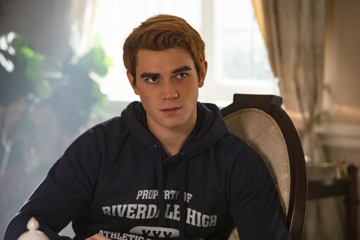Archie from &quot;Riverdale&quot; sitting on a chair and looking serious