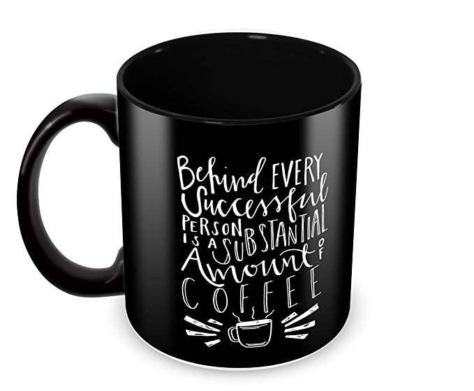 Black mug with the words “Behind every successful person is a substantial amount of coffee” printed on it.