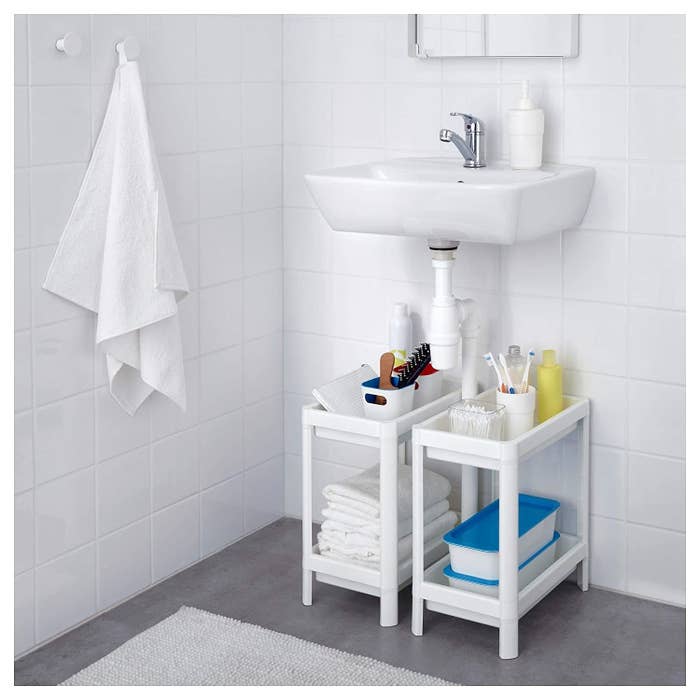 Two IKEA shelving units under a sink.