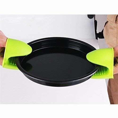 Person holding a baking pan with the green silicone oven mitts.