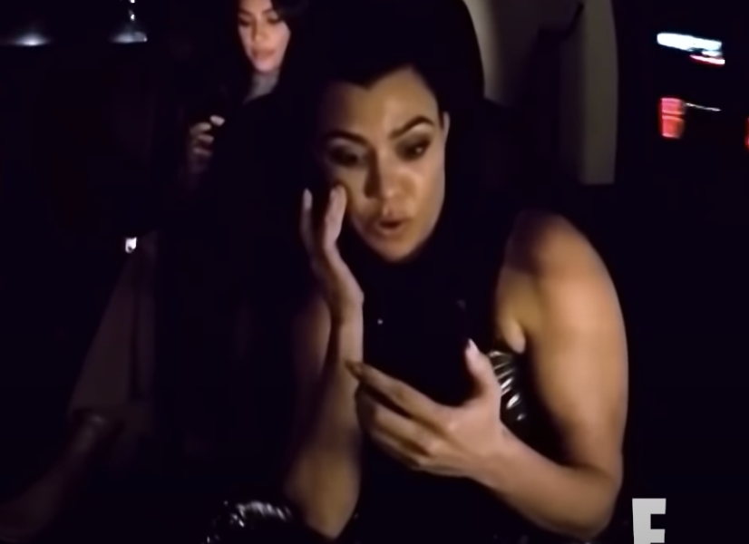 Kourtney on the phone listening to Kendall and Kylie fight
