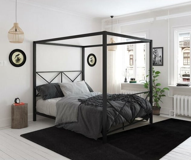 A black metal canopy bed