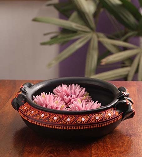 A decorative pot with flowers in it