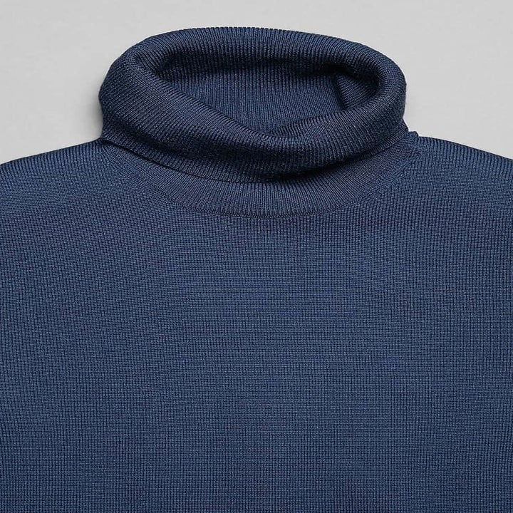 zoomed in flat lay of merino wool turtleneck sweater in navy 