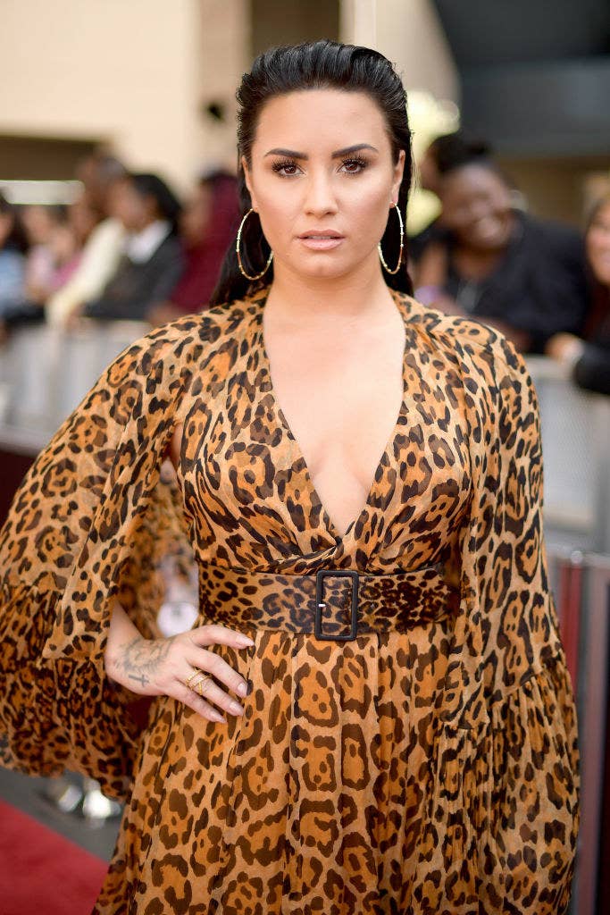 Demi posing in an animal print dress