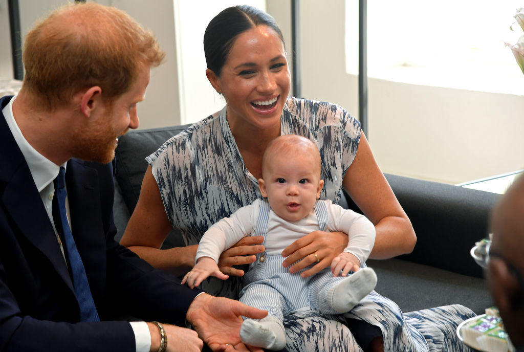 Meghan laughing with Archie on her lap