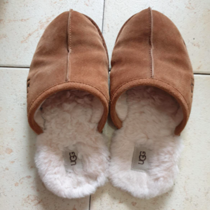 reviewer photo of Ugg slippers on tile flooring