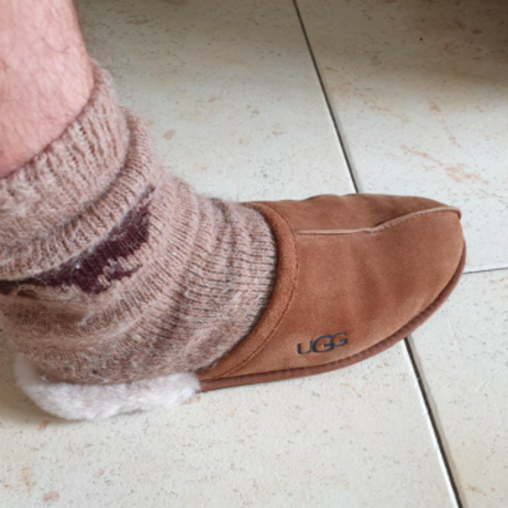 reviewer photo showing slipper on foot with a thick sock