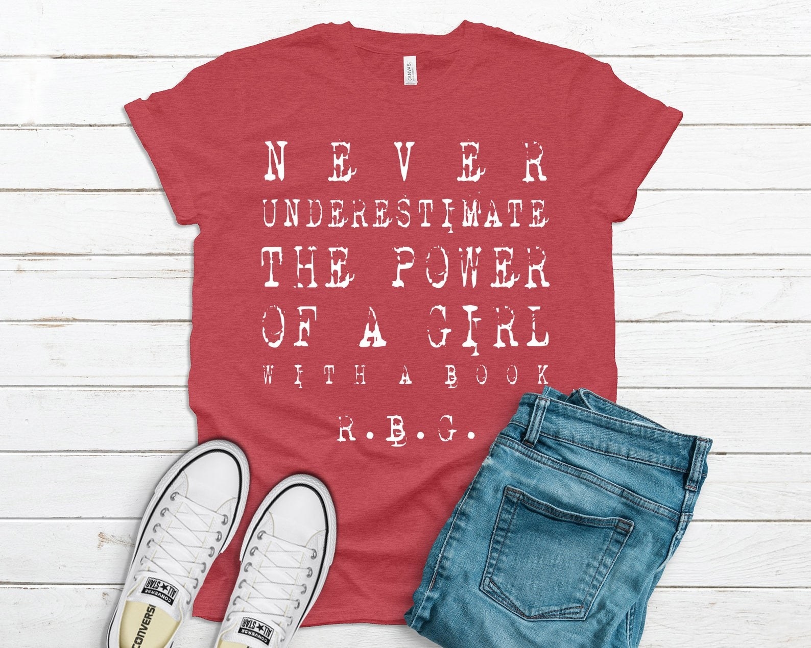 Red t-shirt with the quote &quot;Never underestimate the power of a girl with a book&quot; by RBG