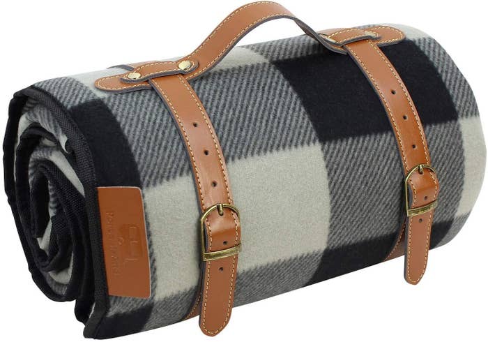 plaid blanket with leather strap and carrying handle