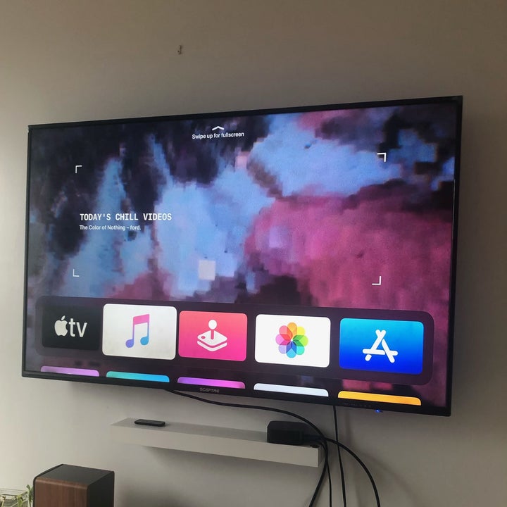 The Apple TV displaying apps on a television