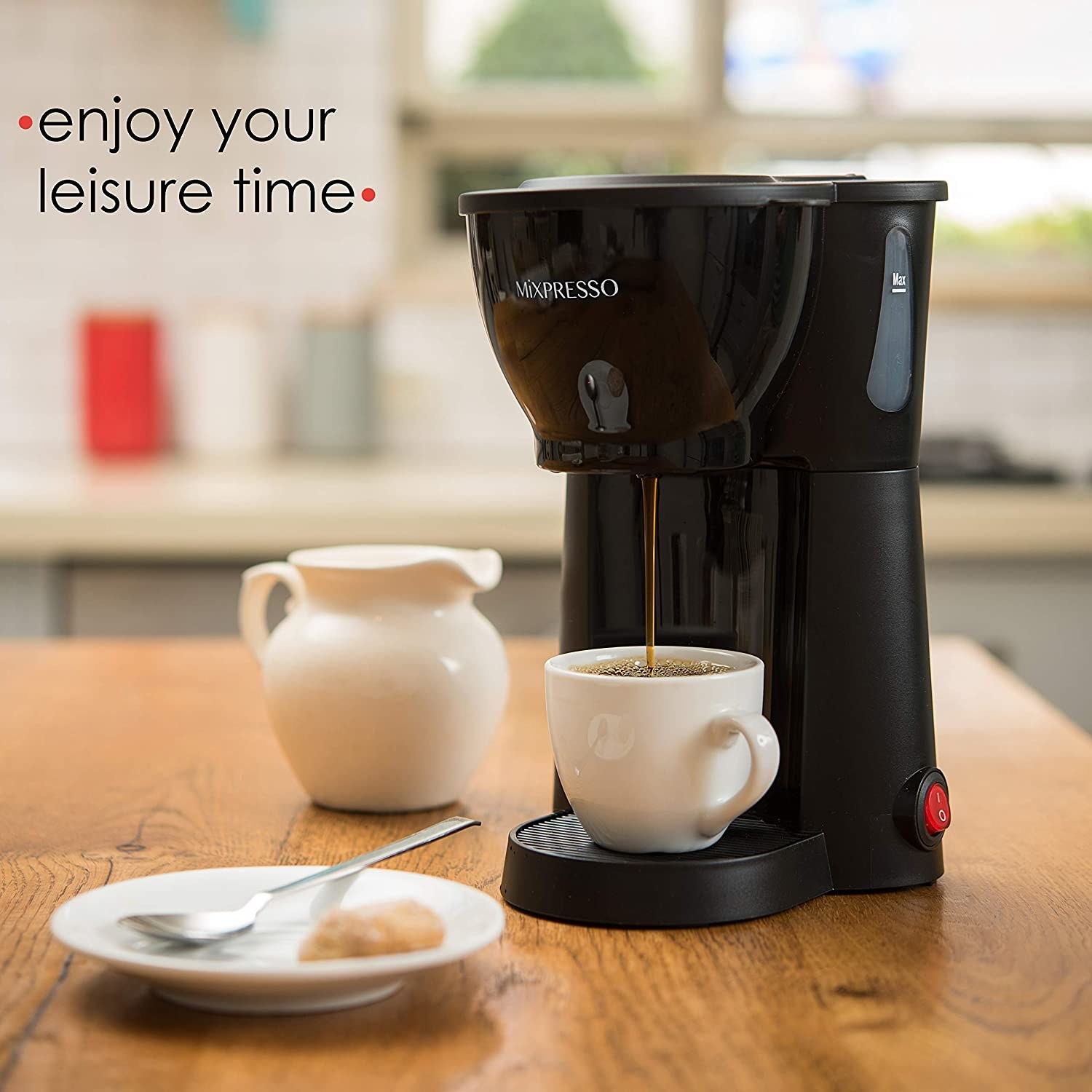 The coffee maker dispensing coffee into a cup