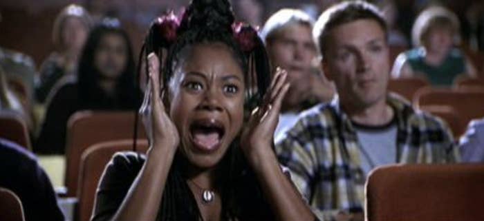 Regina Hall's character watching a scary movie in a theater in "Scary Movie"