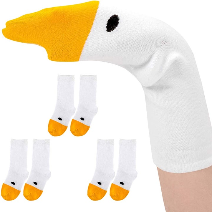 white socks with orange beak toes and black eyes that becomes a hand puppet