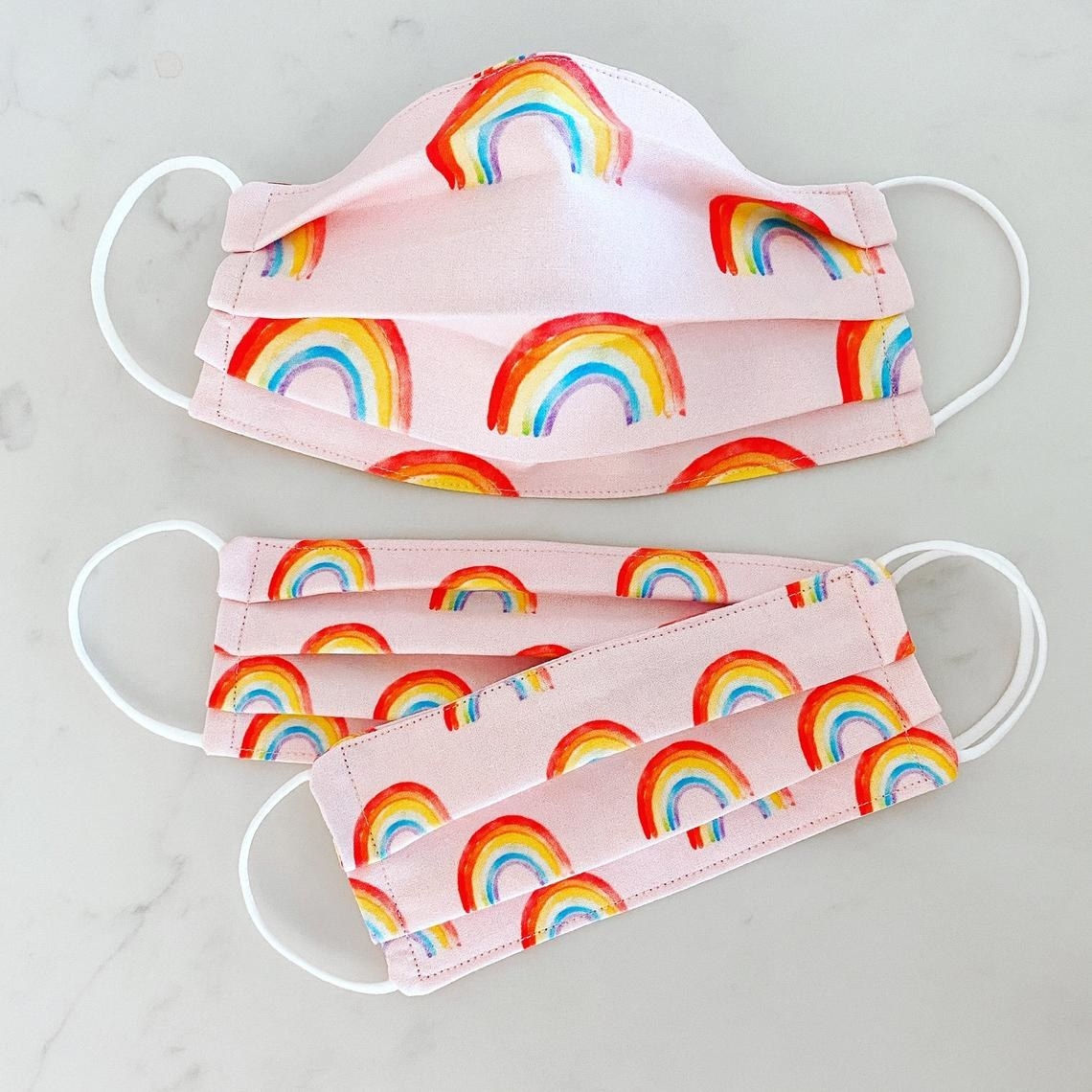 pink accordion mask with rainbows on it 