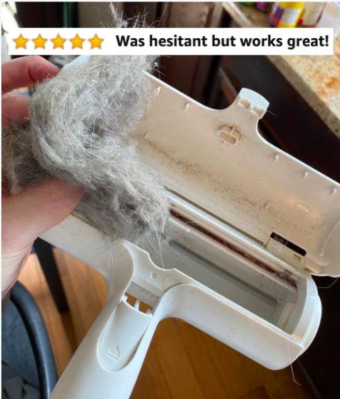 Reviewer pulling fur out the fur-collecting roller with five-star caption &quot;was hesitant but it works!&quot; 
