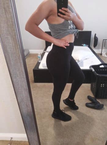 reviewer poses in same style leggings in a black color