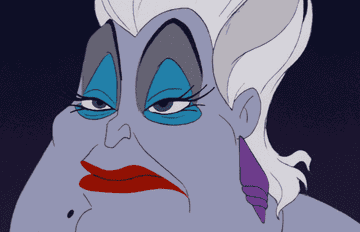 A GIF of Ursula giving an evil smilt  