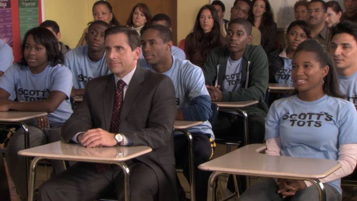 Michael Scott looks awkard with the Scotts Tots kids