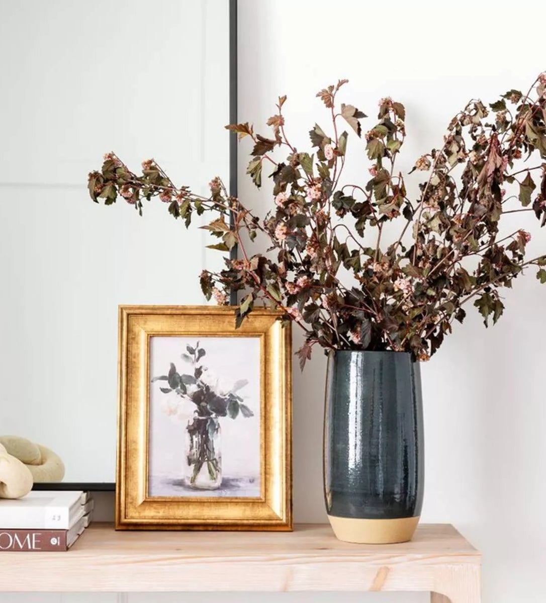 The vase with flowers on an entryway table