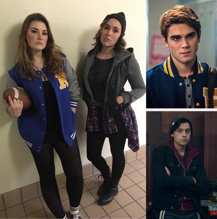 One woman with a letterman jacket and a football, another woman with a beanie, leather jacket, and plaid flannel tied around waist. 