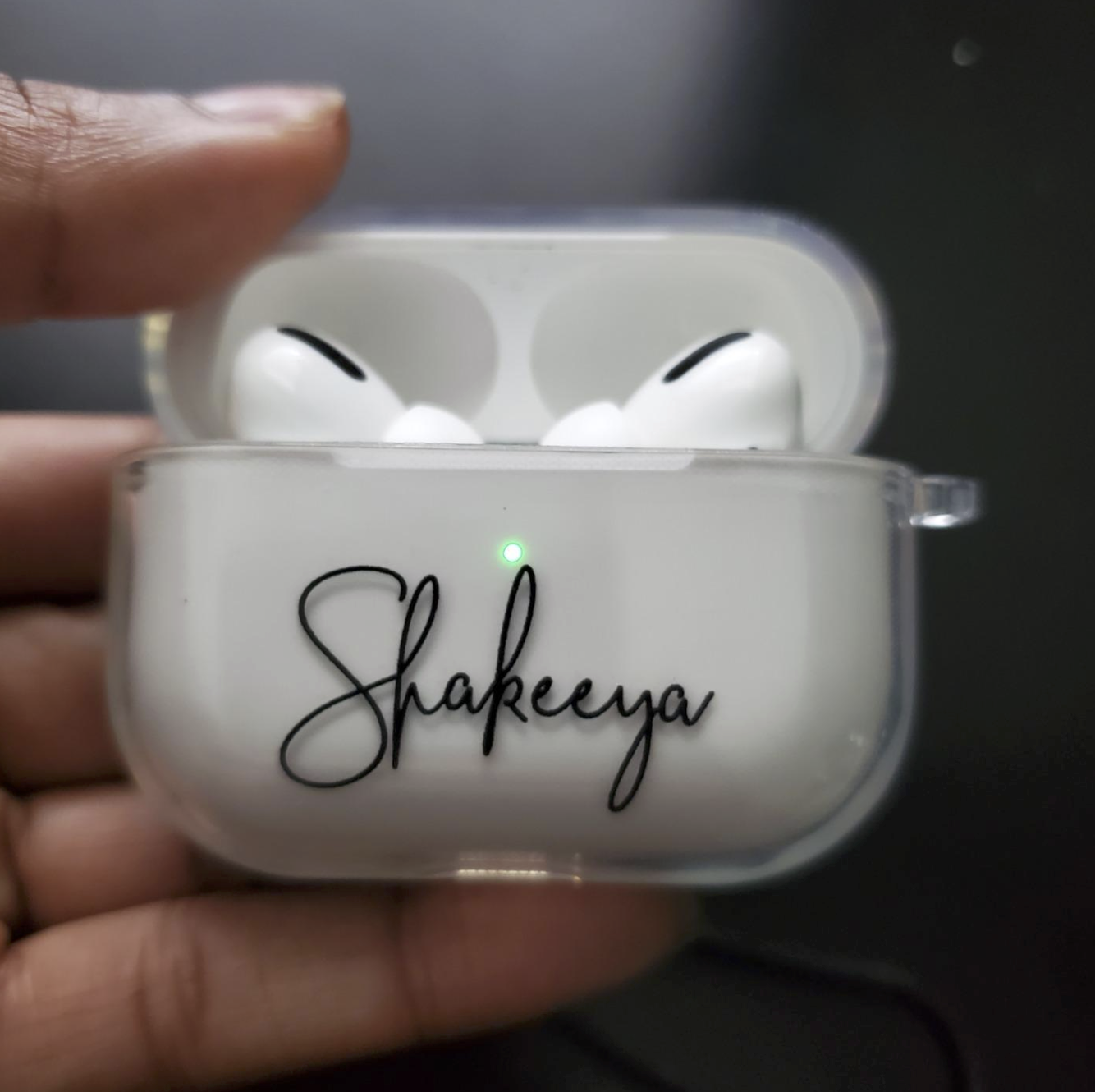 Reviewer&#x27;s white Airpods case that says the name &quot;Shakeeya&quot; in a cursive font